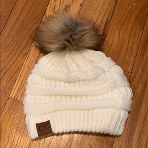 CC cream knit toboggan with brown faux fur ball